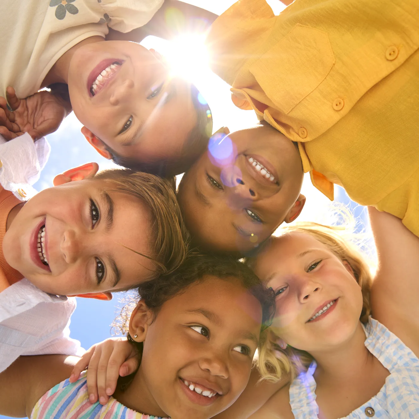 Children smiling together in the sunshine at Heber Valley Pediatrics